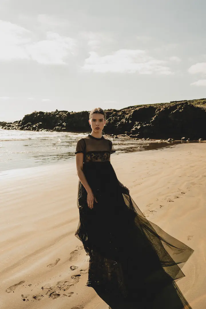 Fotografía de moda en Madrid digital en playa con vestido negro